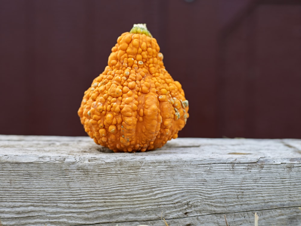 a small pumpkin sitting on top of a wooden table