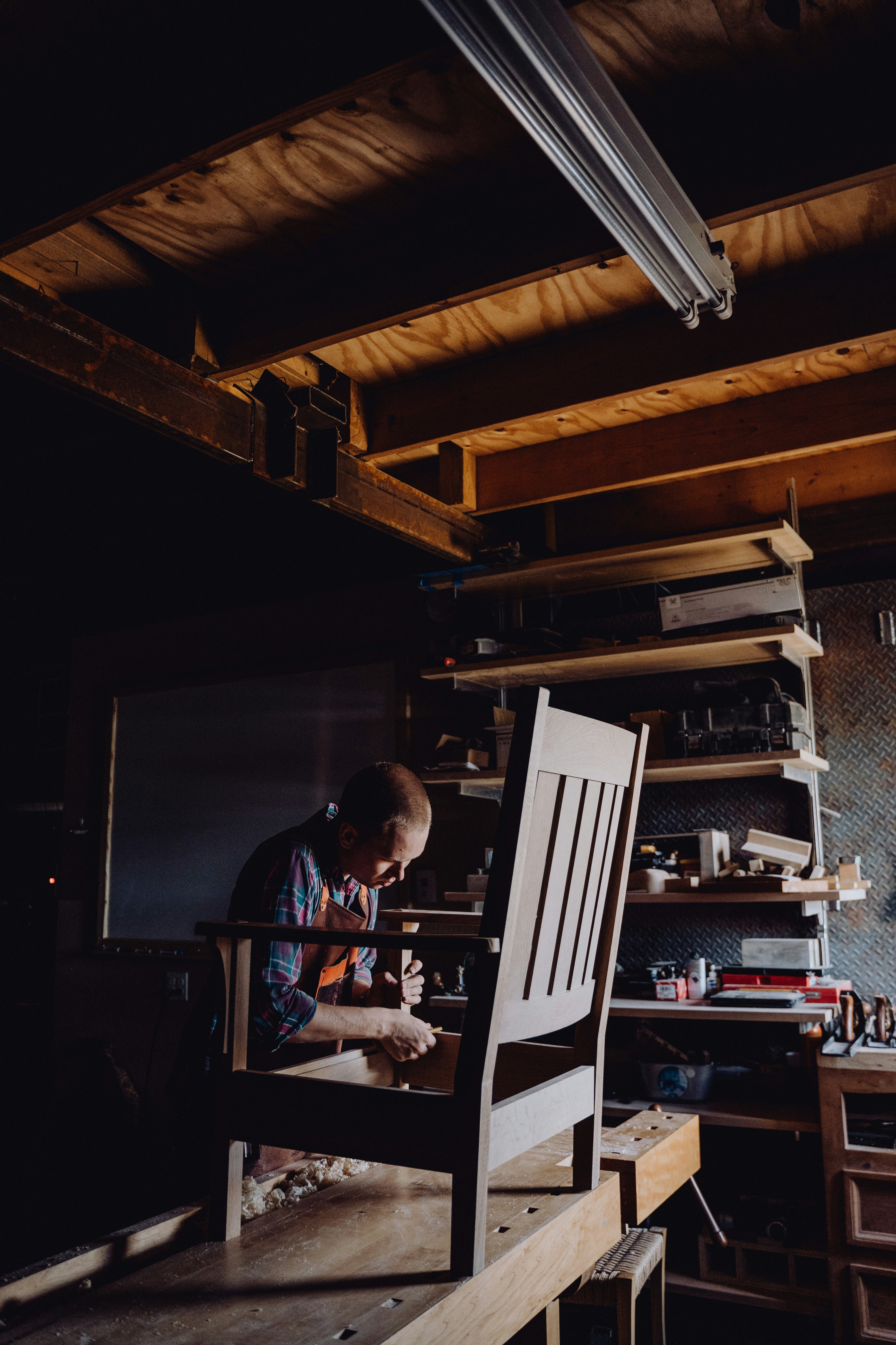 a man working on a chair in a workshop