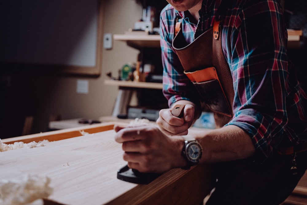 a man working on a piece of wood