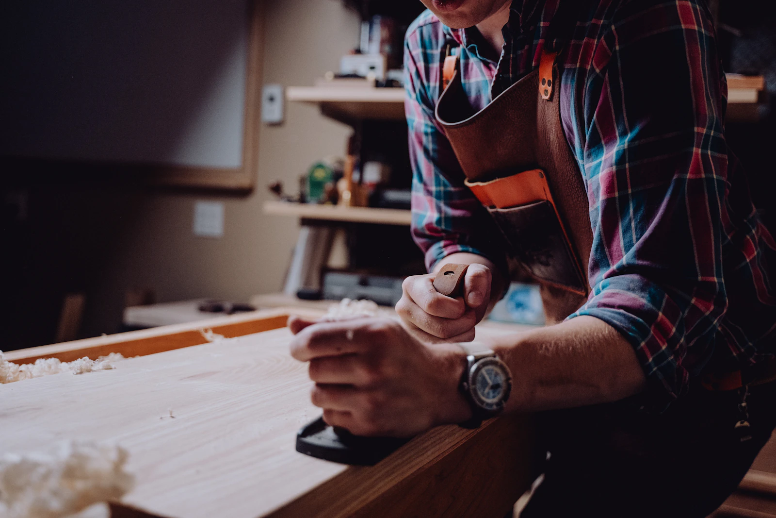 Craftsman's hands working a length of timber