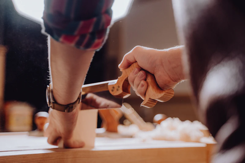 Hands working with woodworking tools and materials