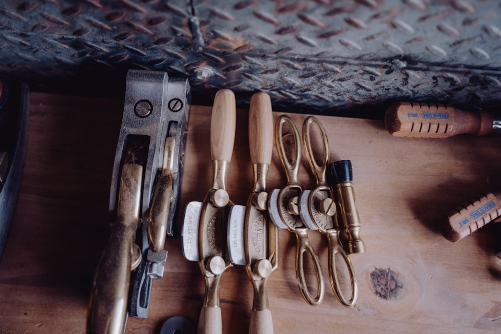 a wooden table topped with lots of different types of tools