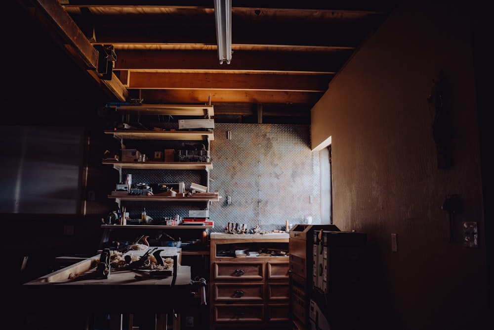 a dark room with a shelf full of clutter