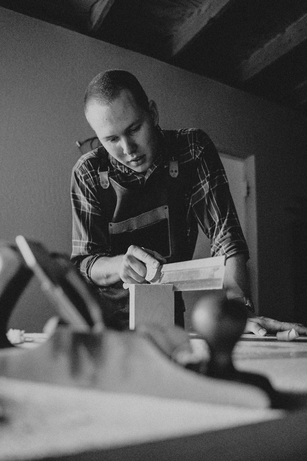 a man is working on a piece of wood