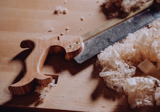 a knife and some wood shavings on a table