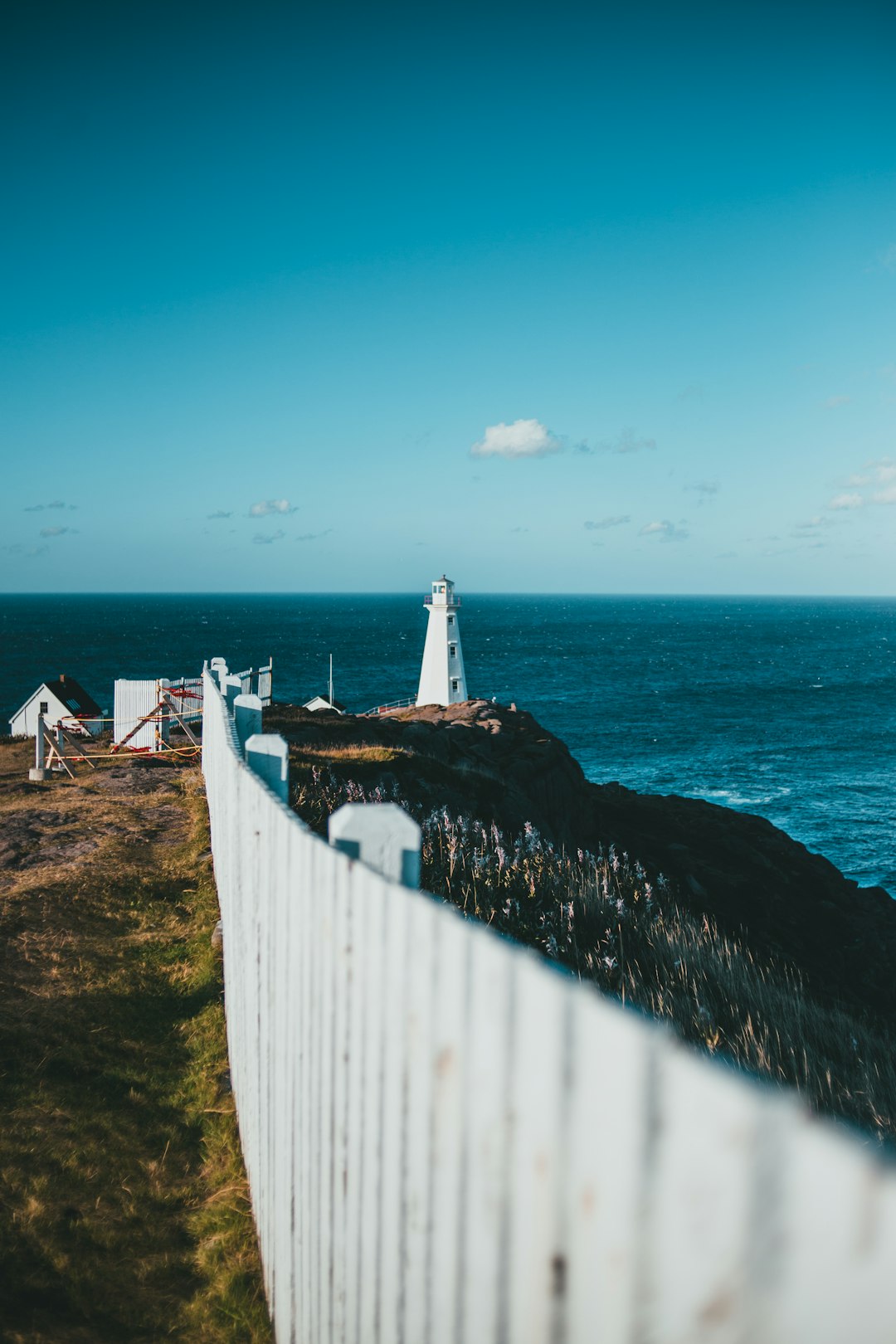 white and brown lighthouse near body of water during daytime