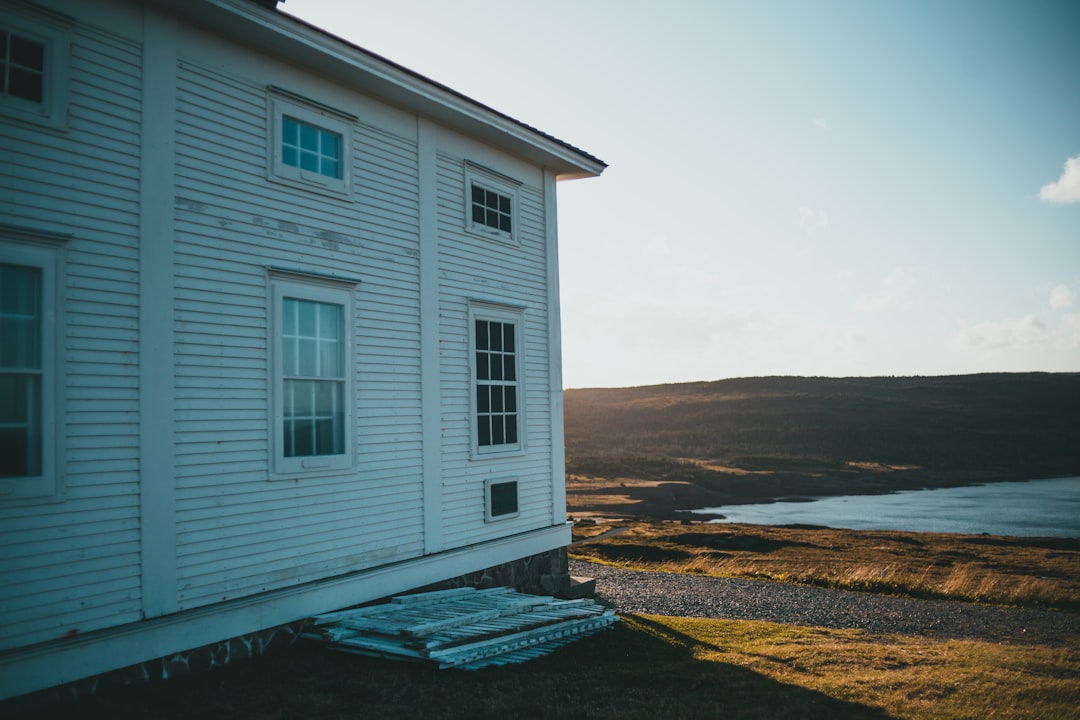 white wooden house near body of water during daytime