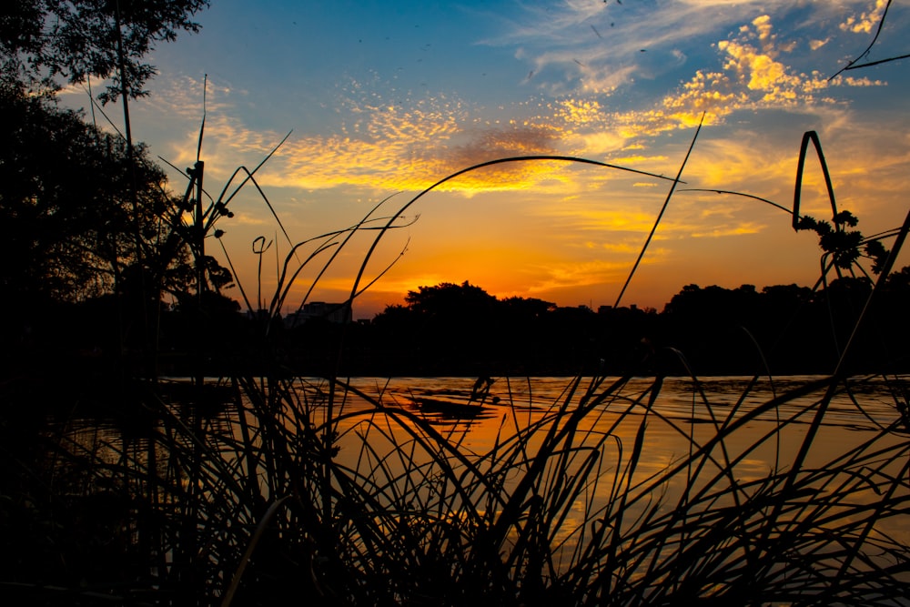 the sun is setting over a body of water