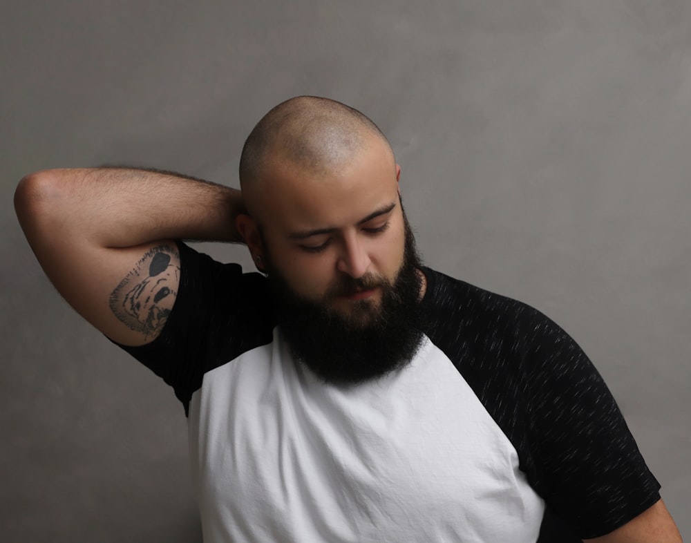 a man with a bald head wearing a black and white shirt