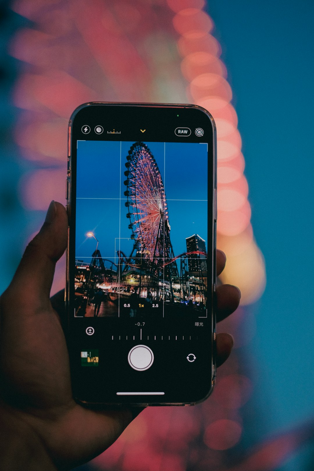 person holding black iphone 4 taking photo of people riding on roller coaster