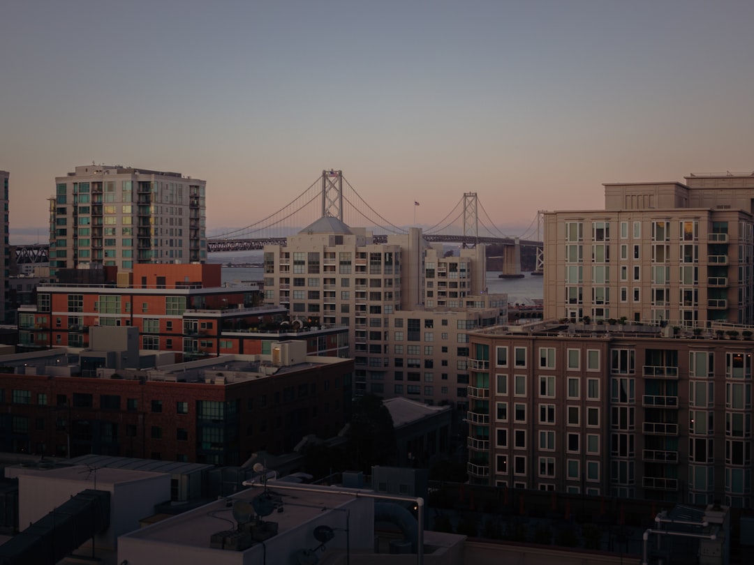 white and brown concrete buildings near bridge during daytime