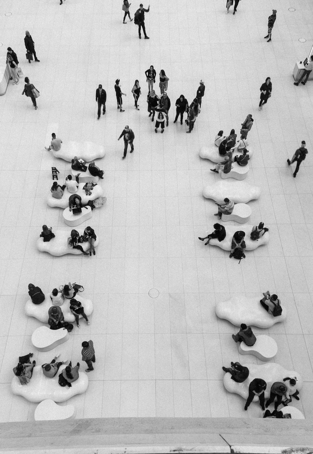 people sitting on white floor tiles