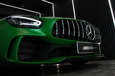 green mercedes benz car in a parking lot