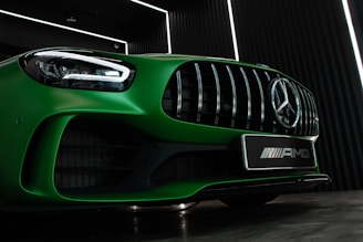green mercedes benz car in a parking lot