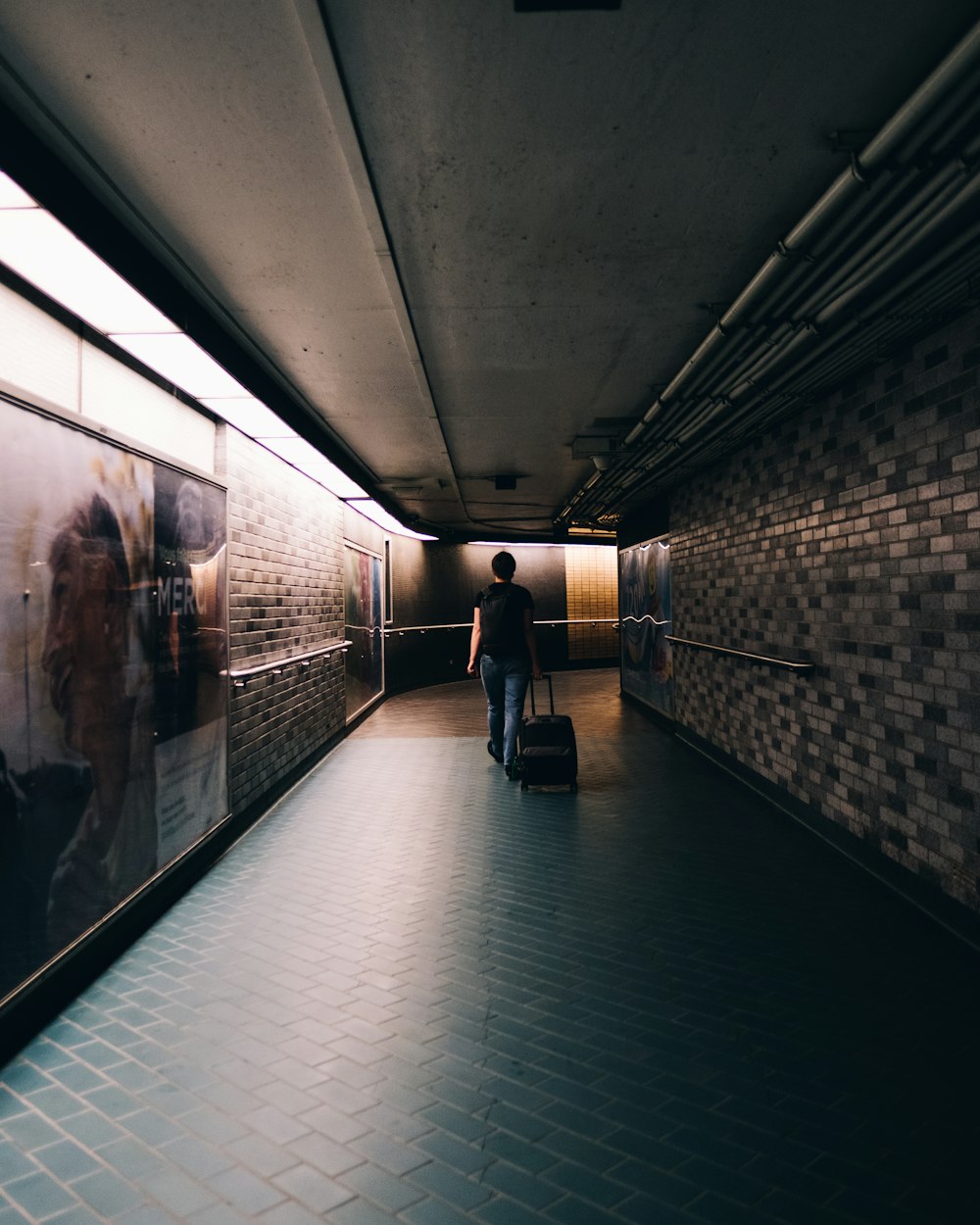 man in black jacket walking on hallway