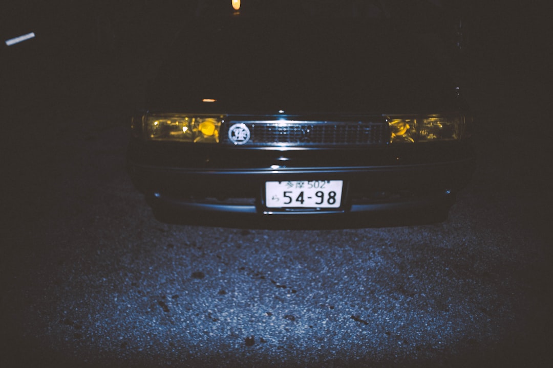 black car on gray asphalt road during night time