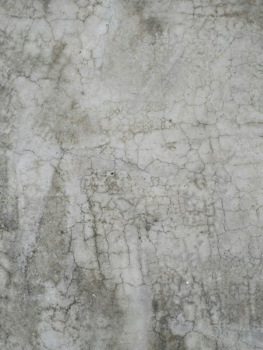 a close up of a cement surface with cracks