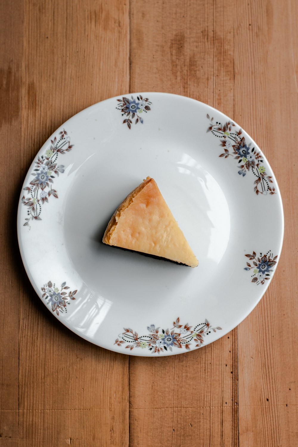 a piece of pie on a plate on a wooden table