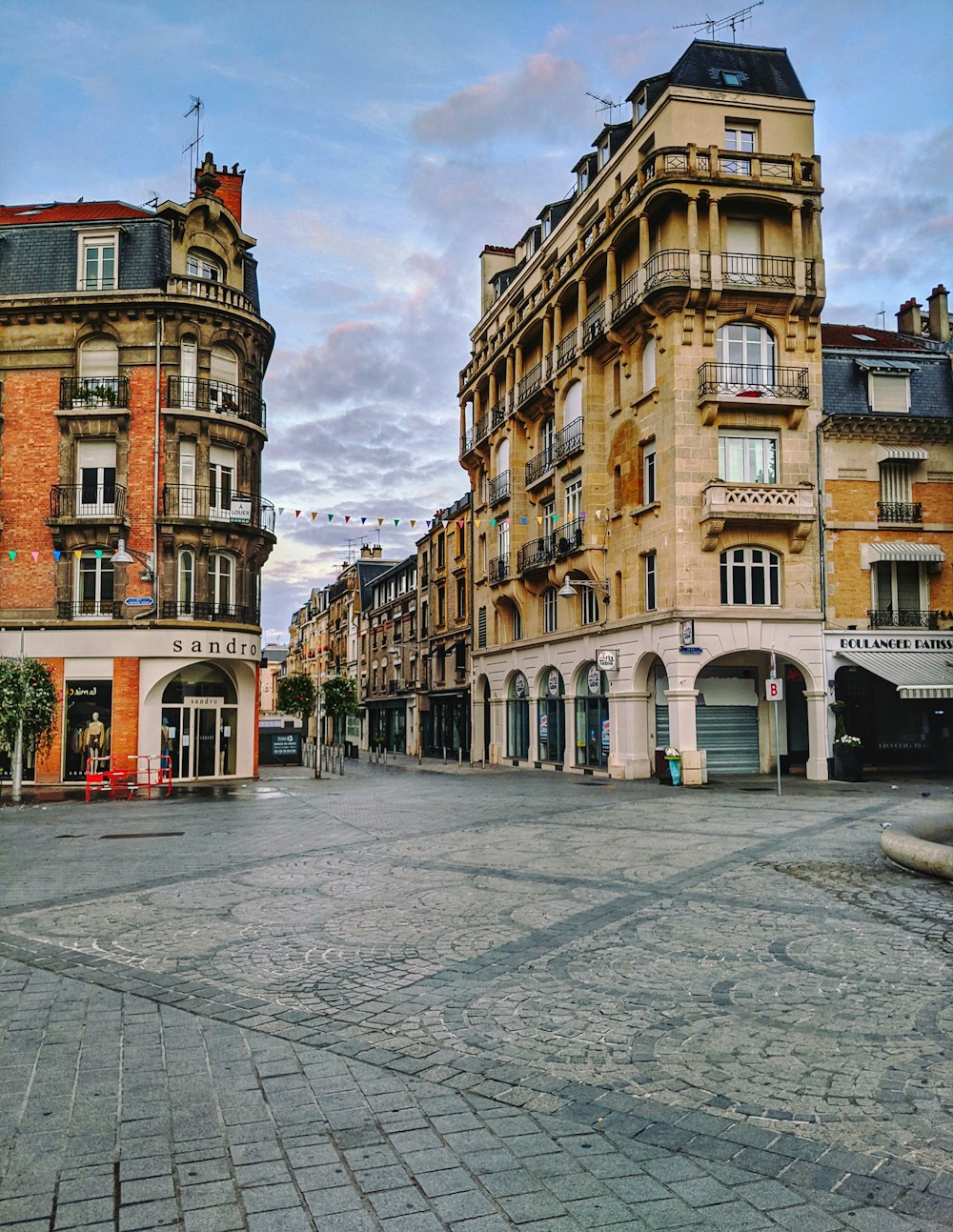 a city square with a clock tower in the middle of it