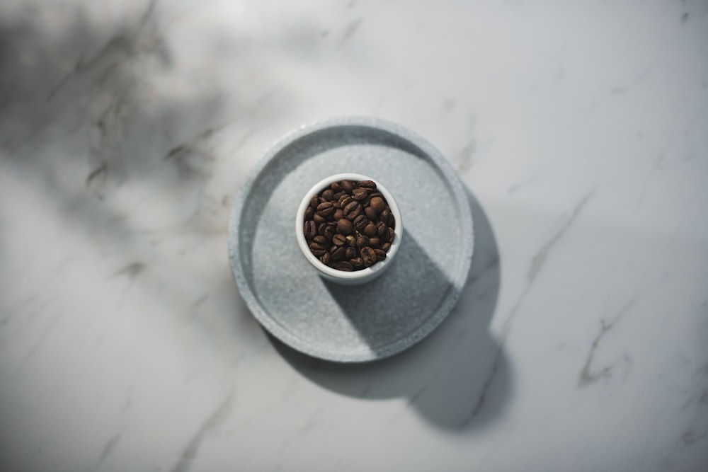 brown round fruit on white round ceramic saucer