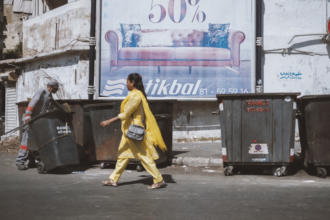 woman in yellow dress walking on street during daytime