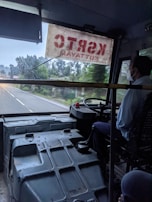 Experienced driver greeting employees boarding a comfortable mid-size shuttle.
