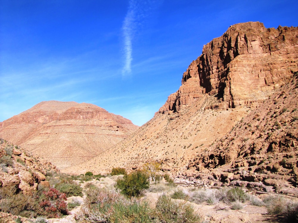 a mountain range with a blue sky in the background