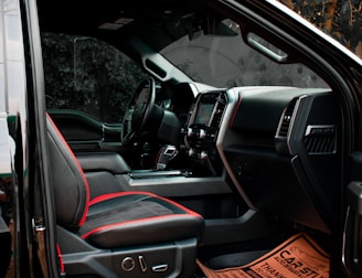 the interior of a vehicle with a red seat belt
