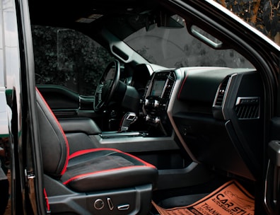 the interior of a vehicle with a red seat belt