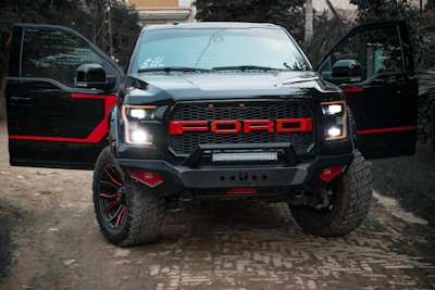 A rugged pickup truck parked on a gravel road, ready for export.