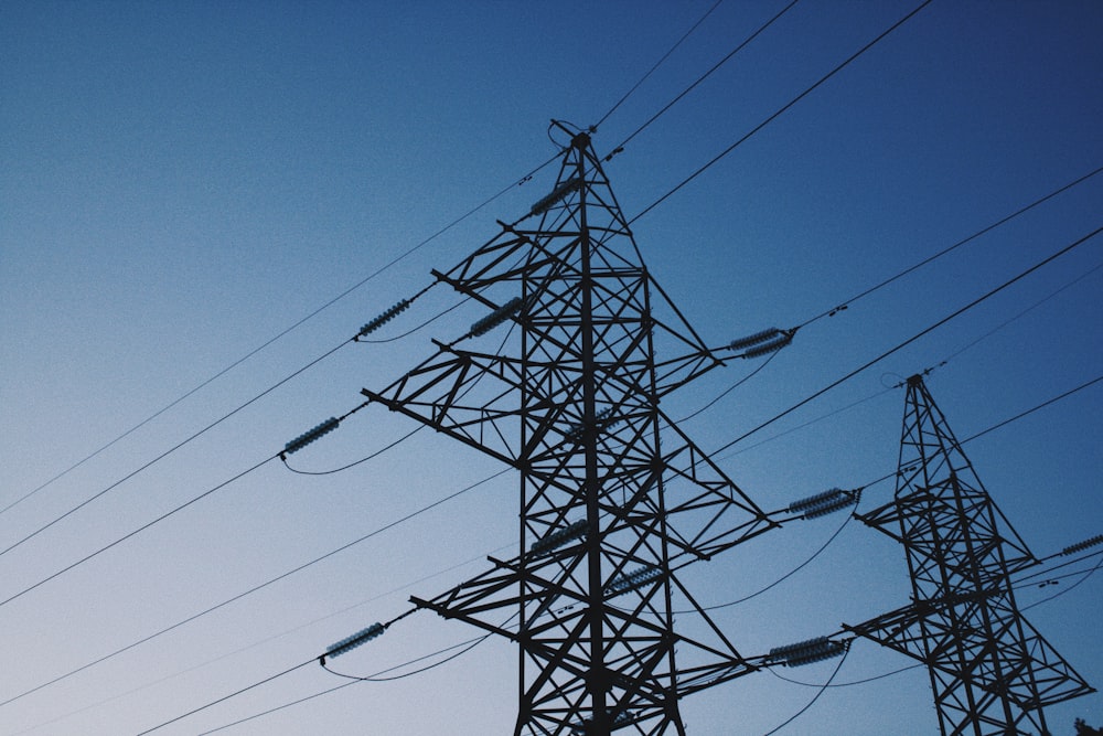 a high voltage power line against a blue sky