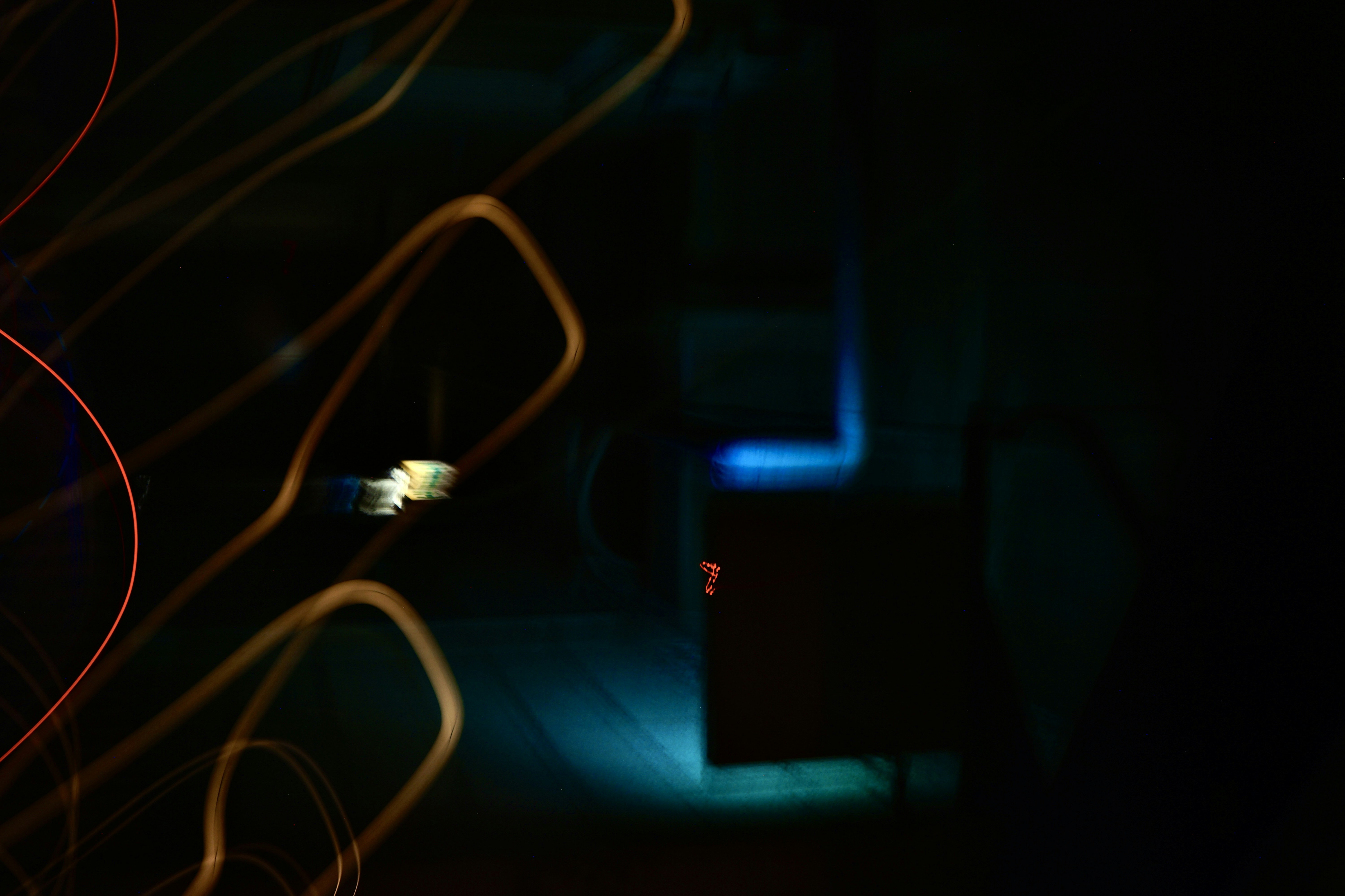 a blurry photo of some wires in the dark