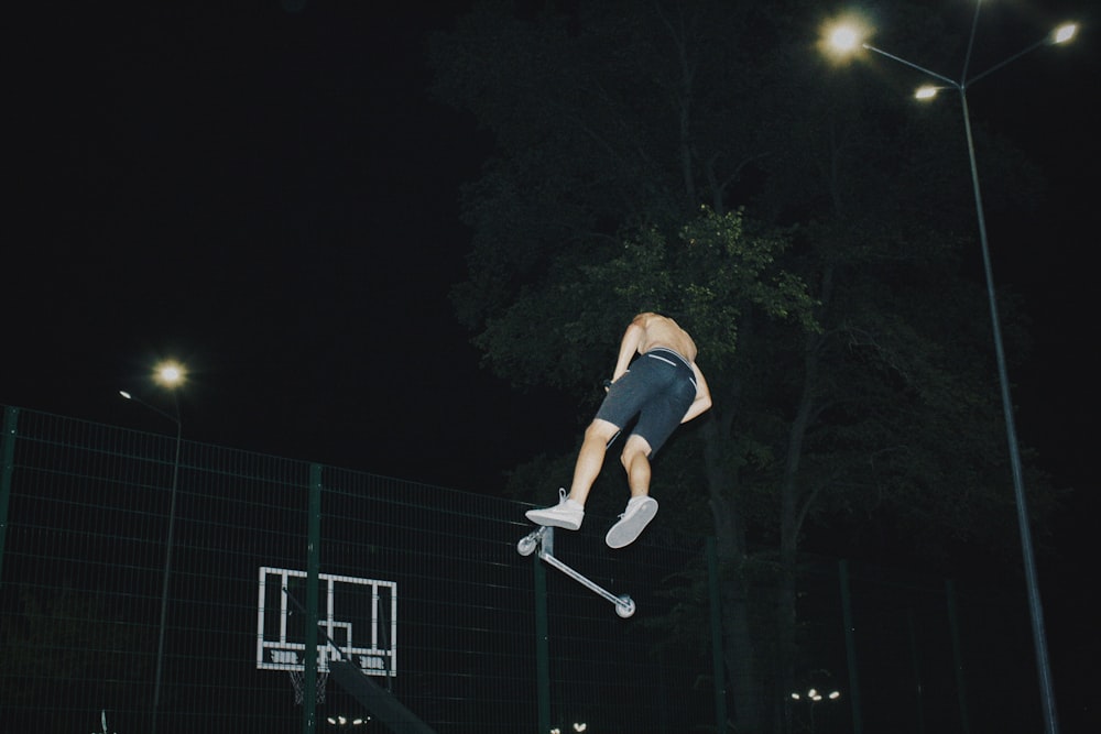 a man flying through the air while riding a skateboard