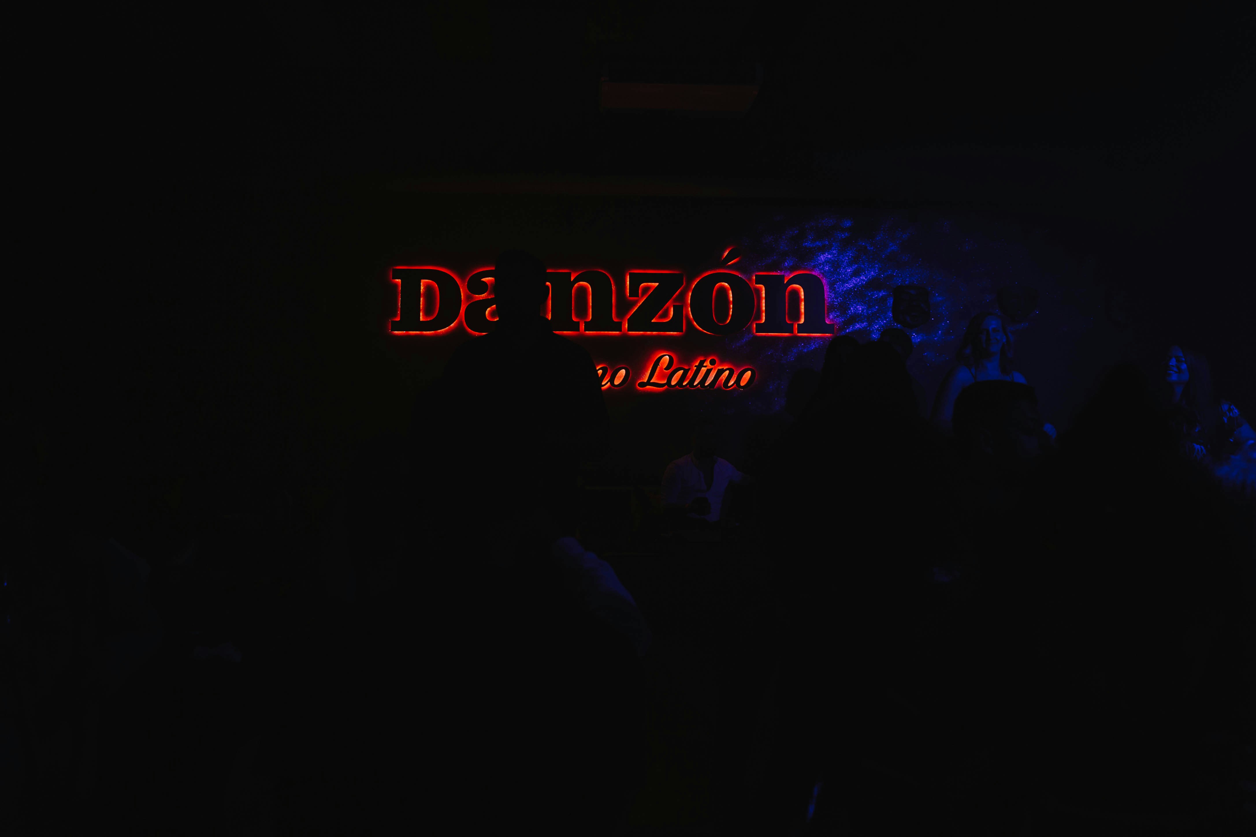 a group of people standing in a dark room