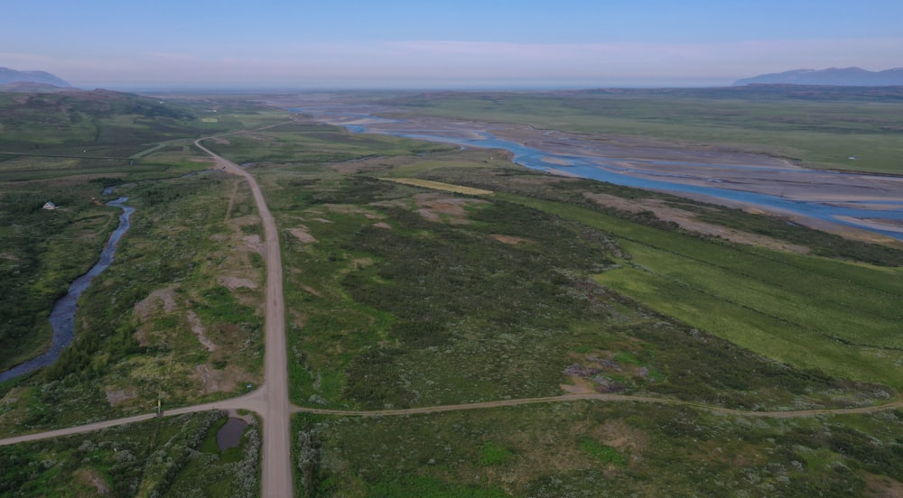 an aerial view of a road and a river