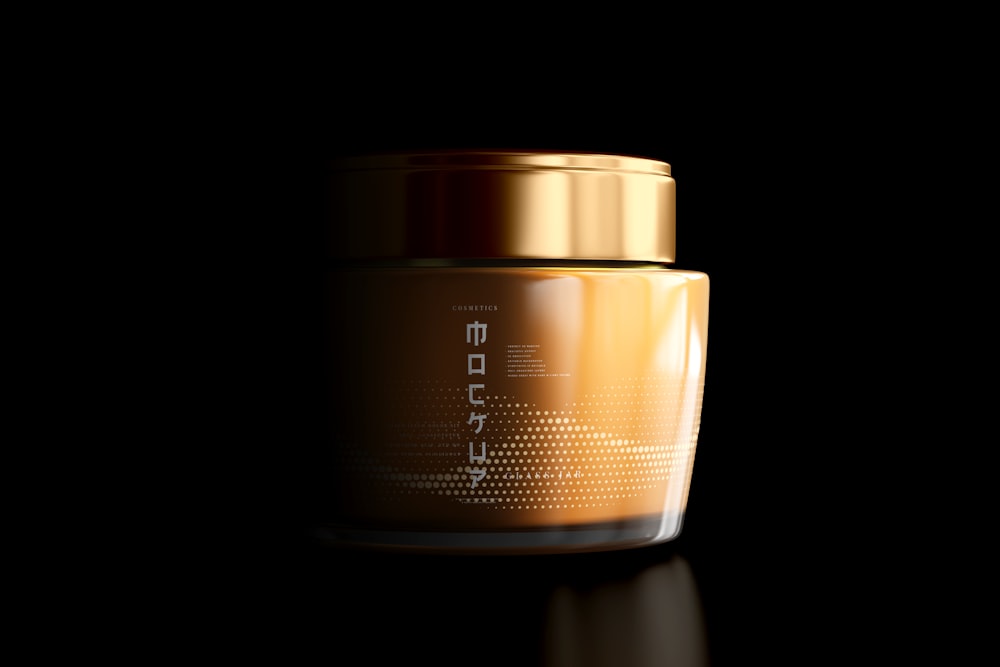 a jar with a gold lid on a black surface