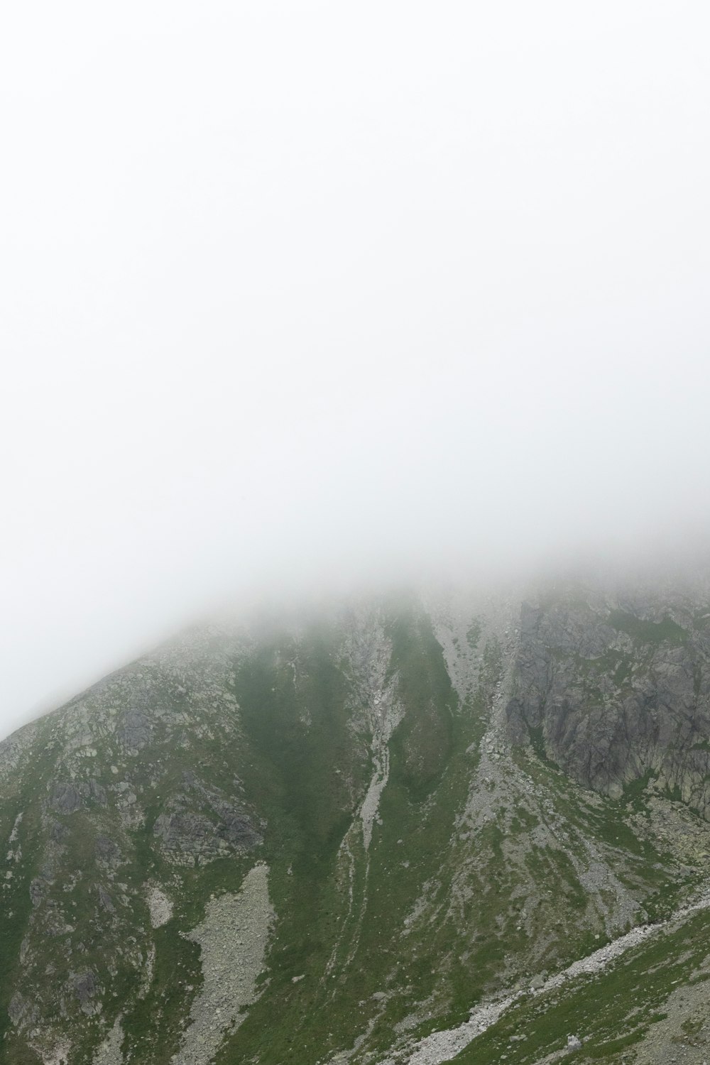 a mountain covered in fog and low lying clouds