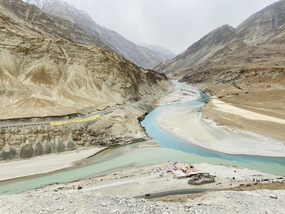 a river running through a valley surrounded by mountains