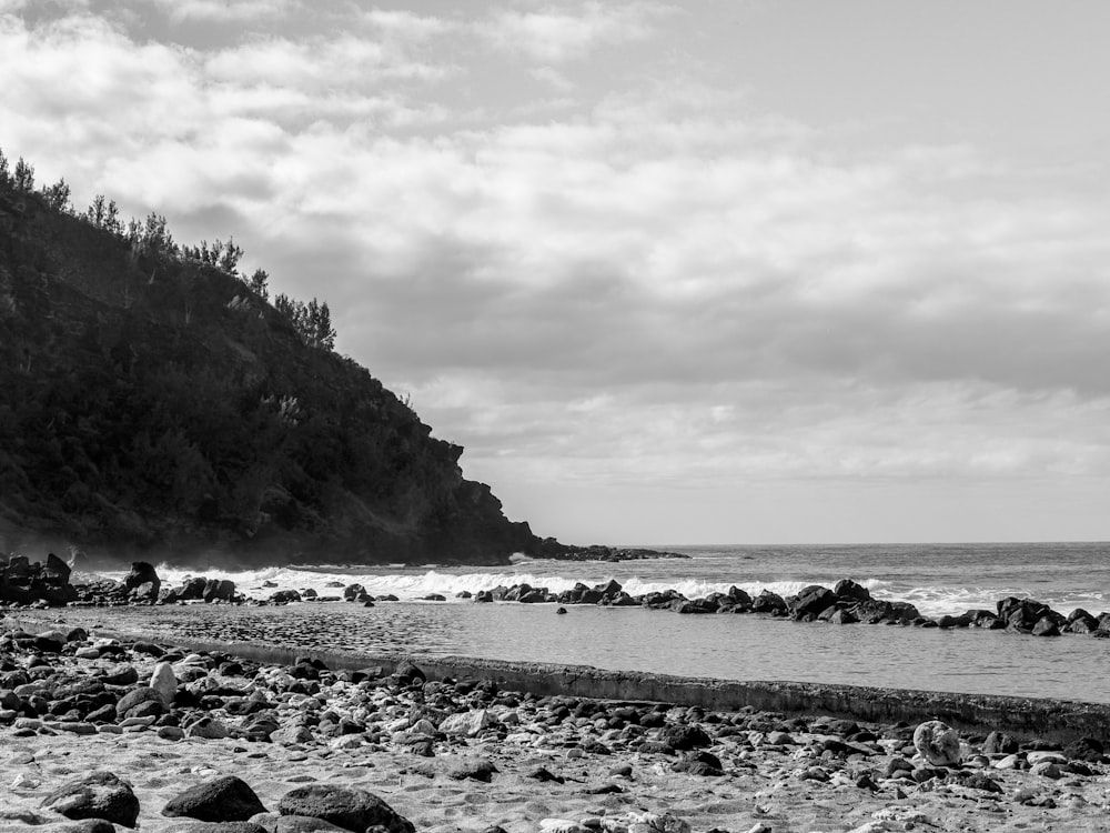 a black and white photo of a rocky beach