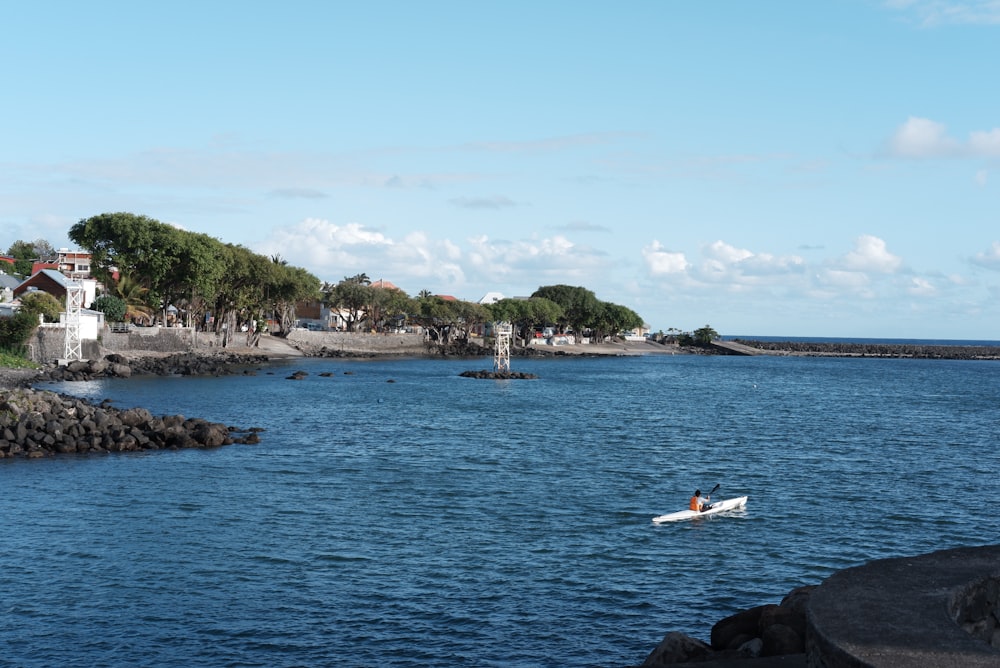 a person in a small boat on a body of water