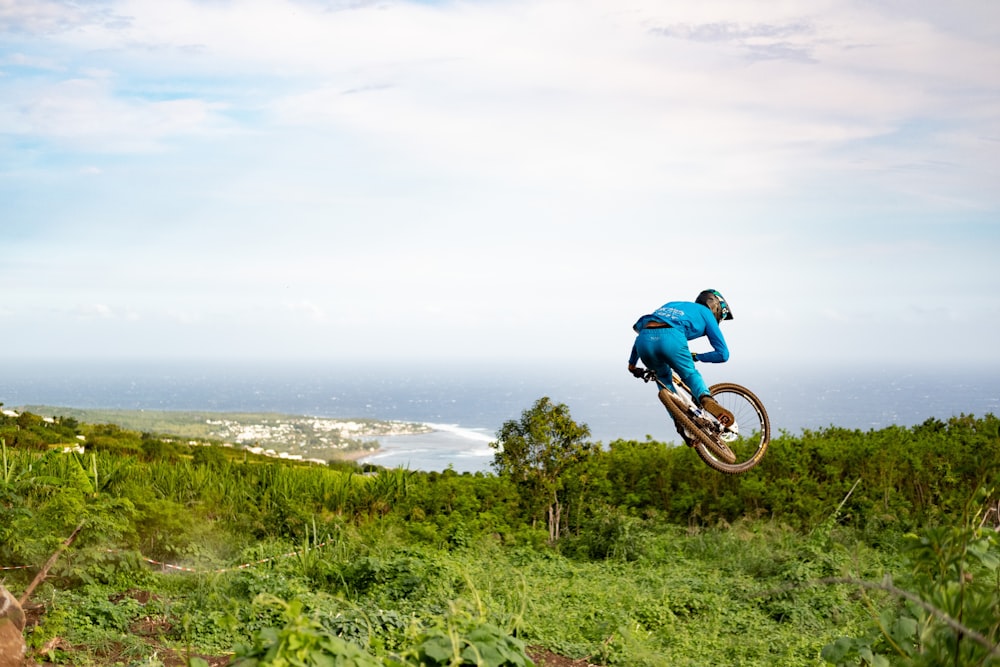 a man riding a bike up the side of a hill