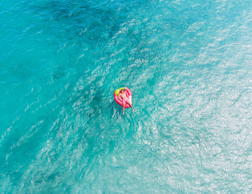 yellow and pink inflatable ring on water