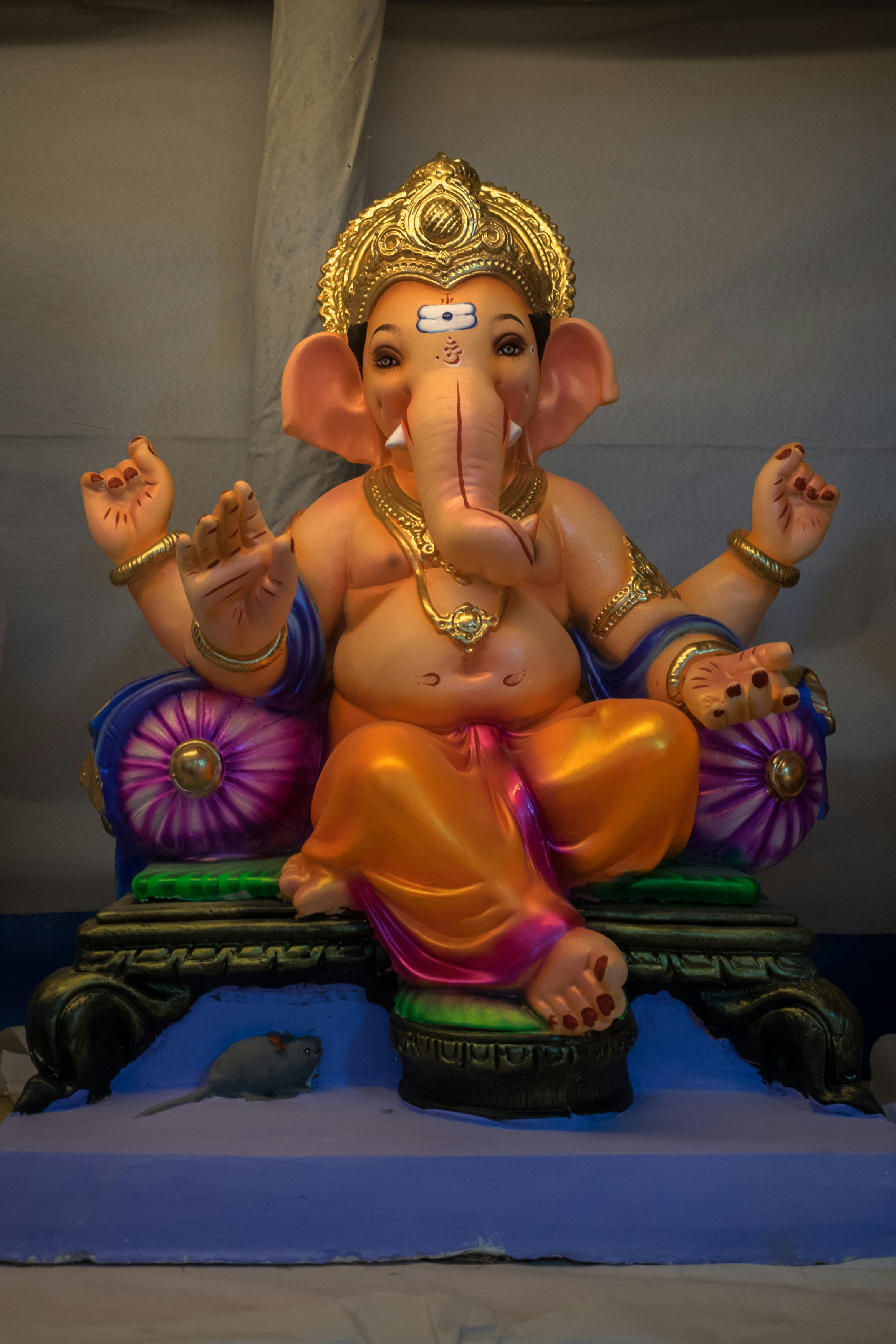 gold hindu deity figurine on blue textile