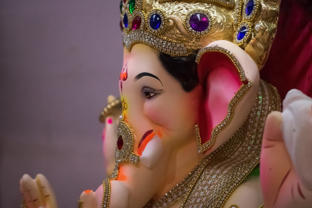 woman wearing gold crown and gold crown