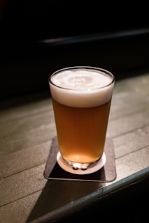 clear drinking glass with brown liquid