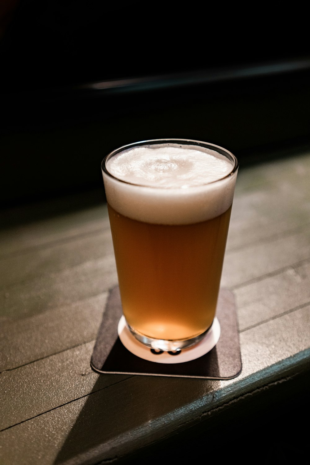 clear drinking glass with brown liquid