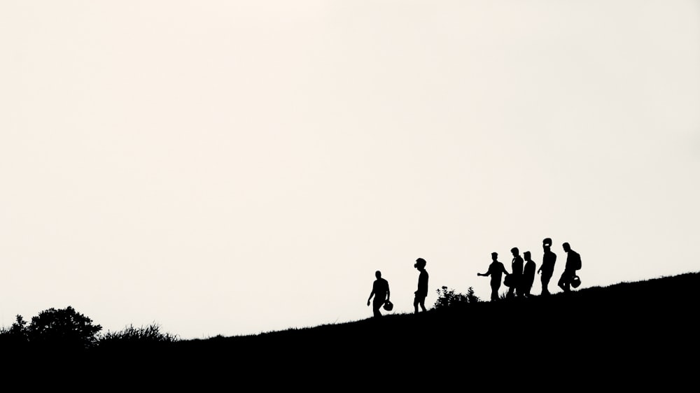 a group of people standing on top of a hill