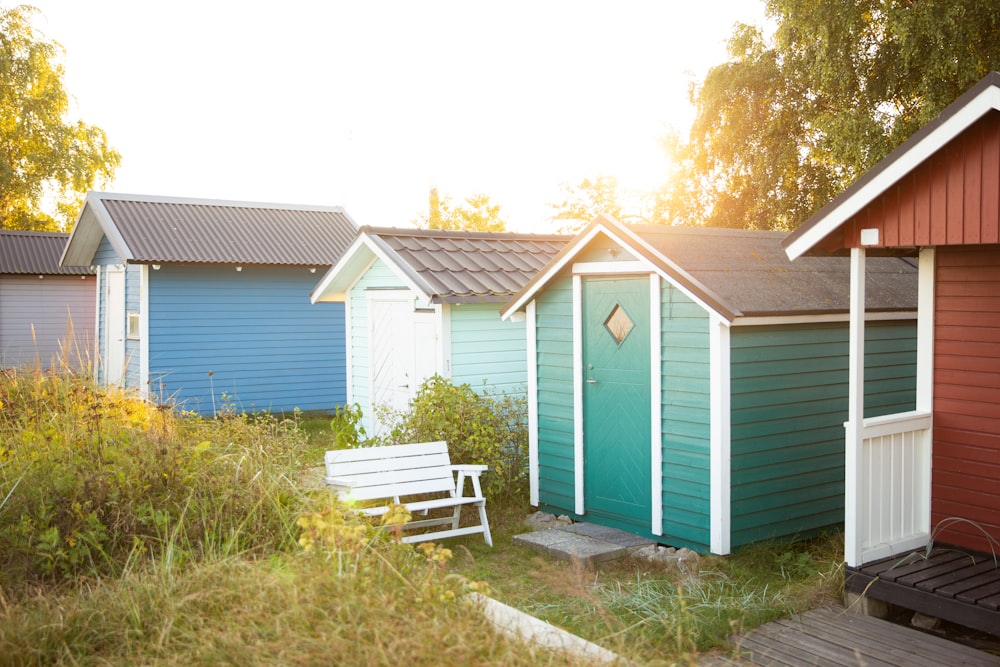 blue and white wooden house near green grass field during daytime