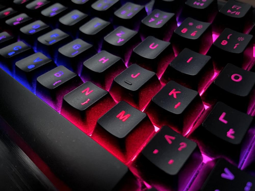 a close up of a keyboard with a red and blue light