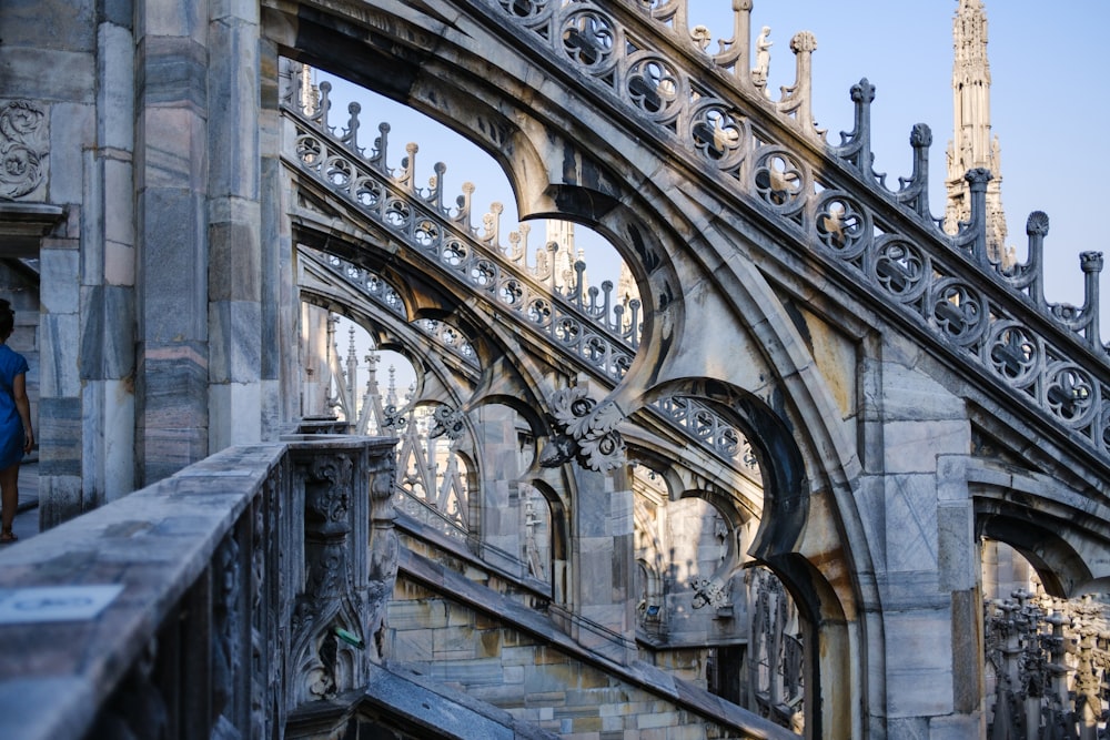 a man standing on a balcony looking at a building